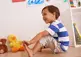 Little boy playing with his toes.