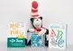 Stuffed cat in the hat toy with two books beside it.