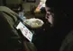 Person sitting and looking at tablet.