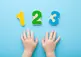 a blue background with childrens hands and the number 1, 2, 3 above them