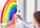 child painting a rainbow